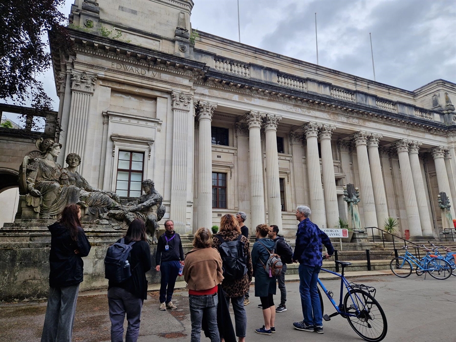 Group listening to tour guide outside Glamorgan