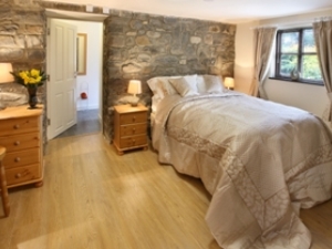A favourite bedroom - lots of old world charm with its stone walls, walk-in wardrobe and en suite shower room.