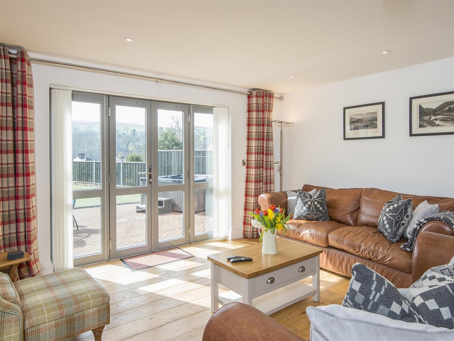 Lounge leading out to hot tub and views of valley