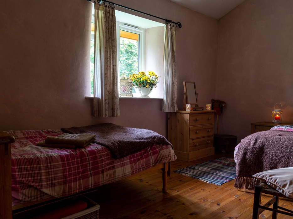 2 twin beds, blankets and hot water bottles, travelling cot.