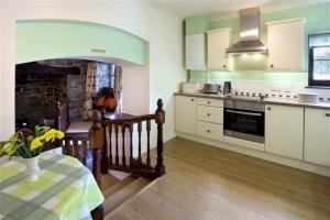 Steps from the living area lead up to this spacious kitchen with its additional dining table.