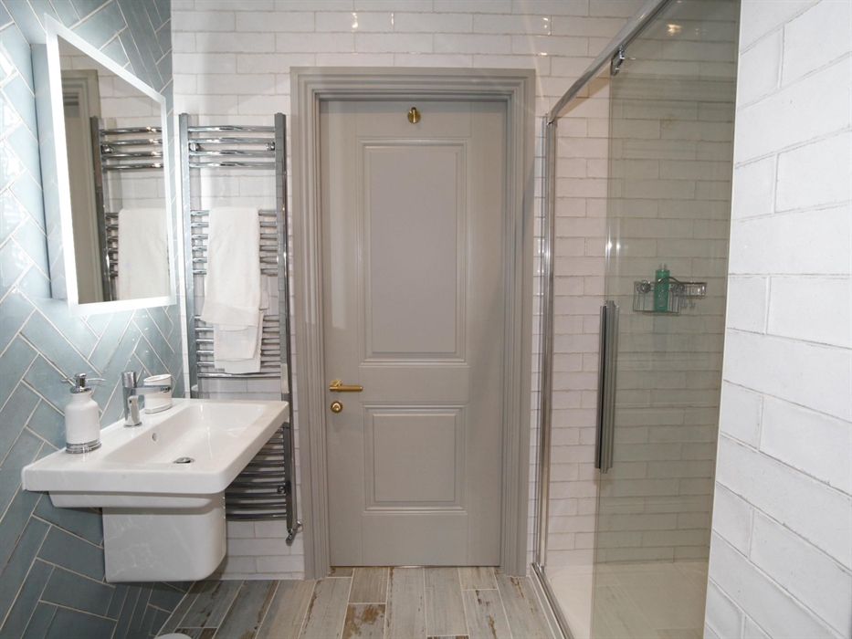 situated on the second floor between the master bedroom and the second bedroom. shower, wc, heated towel rail, bluetooth mirror and basin