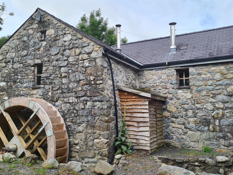 The outside of the mill retains attractive features, including a full size water wheel