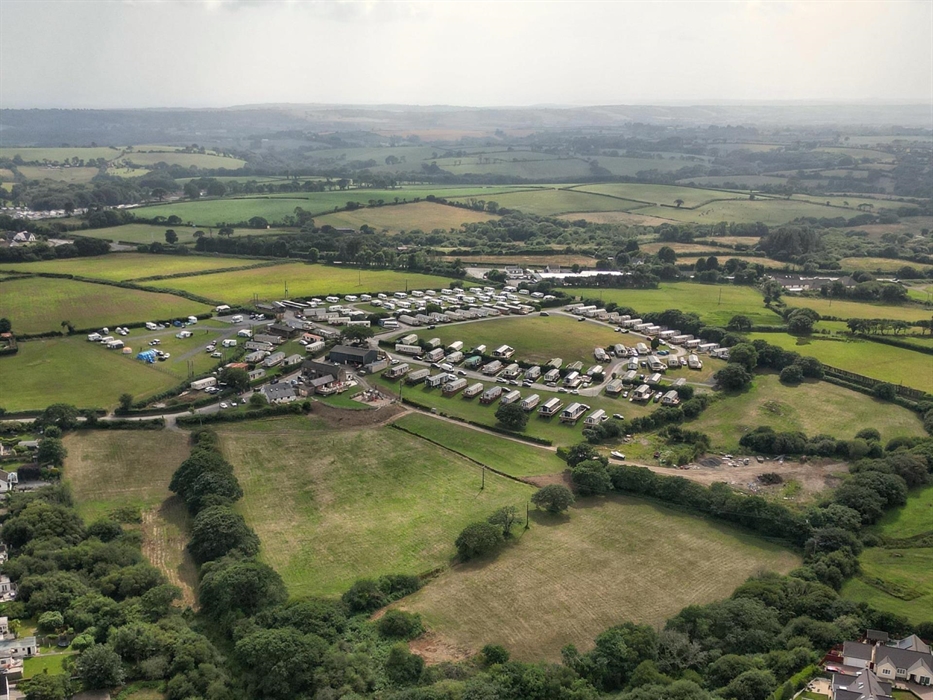 A summer arial shot of the site.