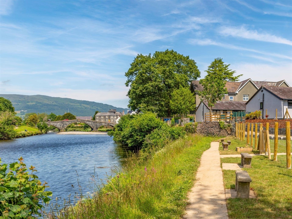 River pathway with view of Llanrwst's stone bridge