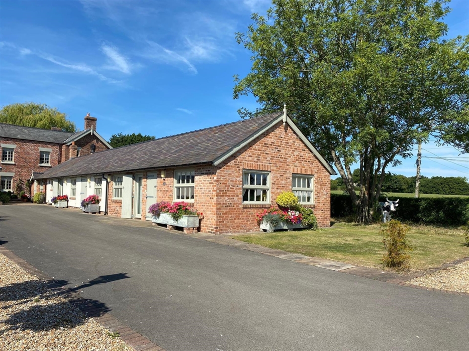 Oak and Holly cottage with the Studio at the far end. Views from the cottages over the field