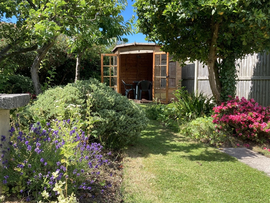 Landscaped gardens with summer house looking back over the garden and towards the mountains