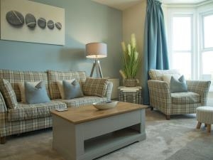 Tastefully decorated, comfortable living room with large bay window to maximise light and views over the estuary and mountain ranges.