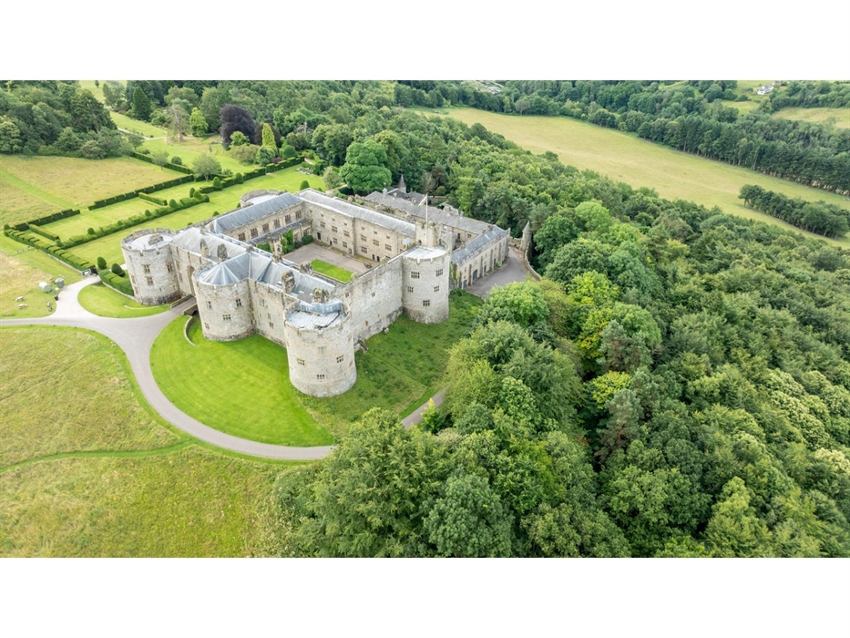 An aerial view of a Chirk Castle surrounded by lush greenery and open fields. National Trust Images/Paul Harris