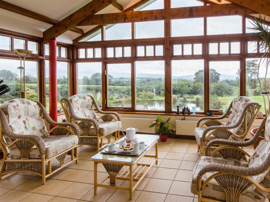 The conservatory set for a welcome afternoon tea.