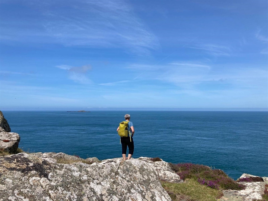 Walker on the cliff edge on the Pembrokeshire Coast path