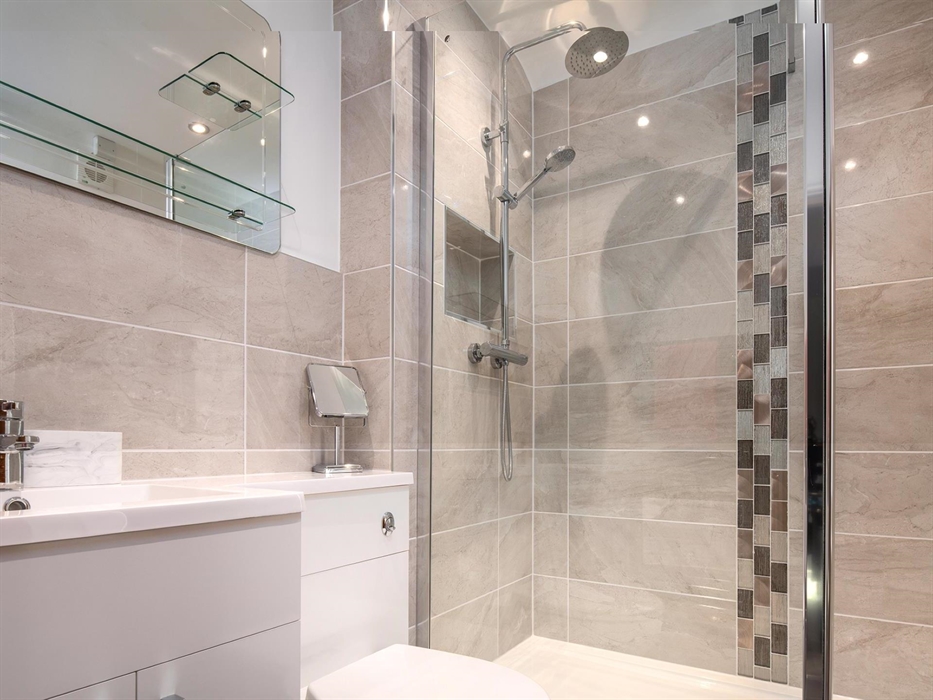 The bathroom has a large walk-in drench shower which runs from the mains water and so has very good pressure.