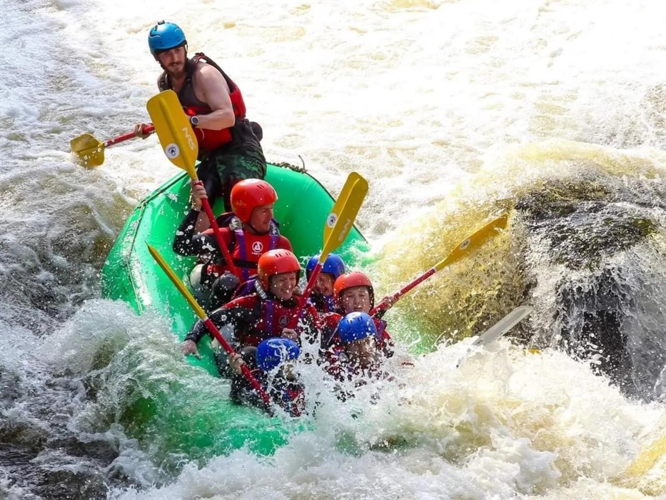 Bearded men adventures, group in raft going down town falls, Llangollen