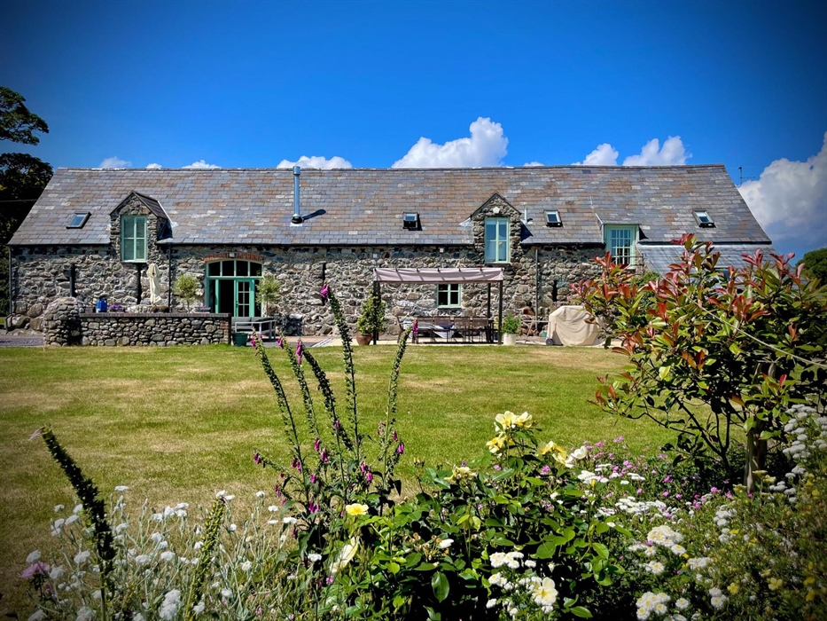 View from the garden across the large lawn towards Ysgubor Degwm barnconversion self catering holiday let in North Wales