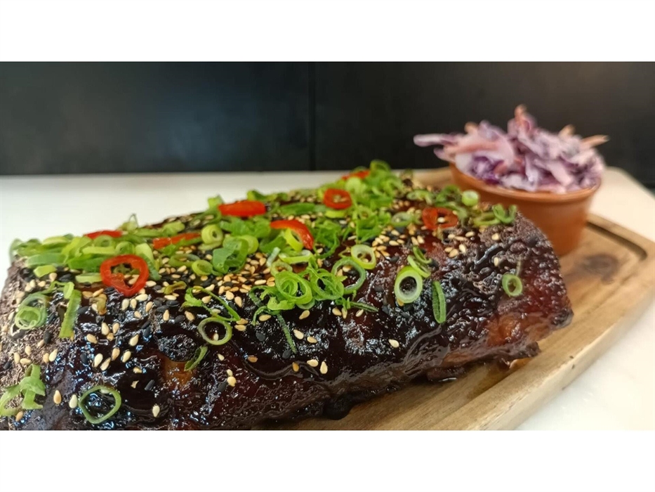 marinated and served with pickled chillies, spring onions, sesame seeds and coleslaw