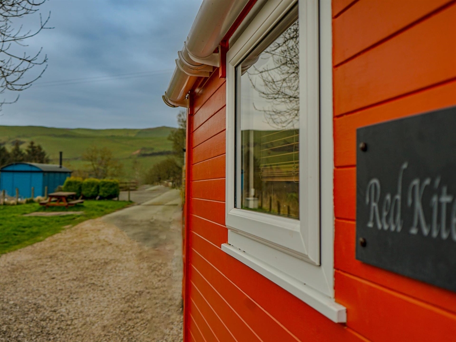 Wild Valley Huts has two traditional shepherds huts. The Red Kite (orange) and The Cuckoo (blue).  Spaced so guests have their own place during their