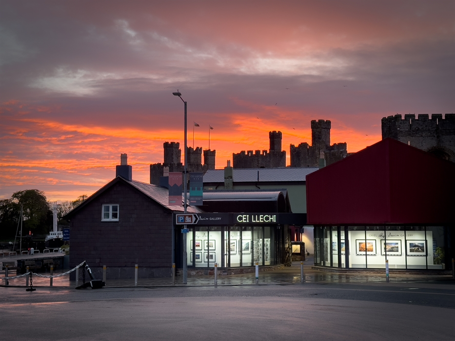 Exterior of the Glyn Davies Gallery at dusk with Caernarfon Castle behind