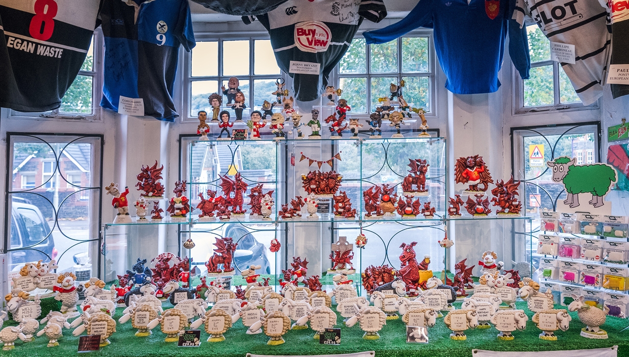 The photo shows a display in the Groggshop complete with red Dragons and sheep with different sayings.