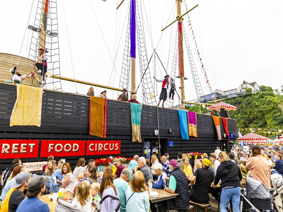 Pirate circus performers entertain the Street Food Circus crowds from the rigging of the replica sailing ship at Saundersfoot harbour