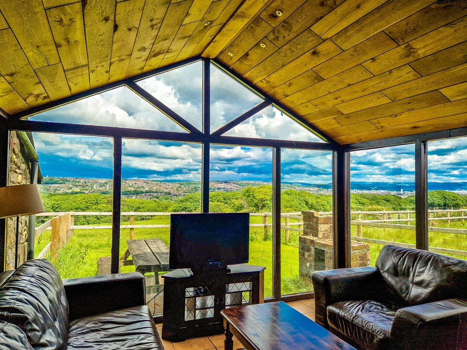 Horseshoe Cottage lounge with views over farmland and Swansea