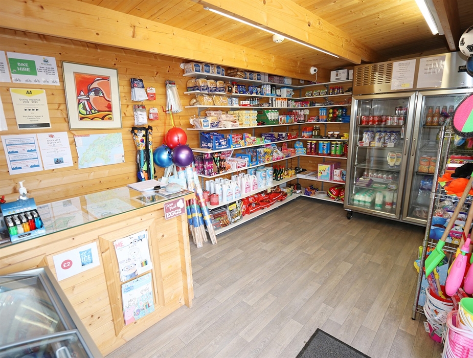 On site shop selling local milk, eggs, bread, ice cream, bagged ice, confectionary, alcohol, cold drinks, food and beach goods. Bike & SUP hire