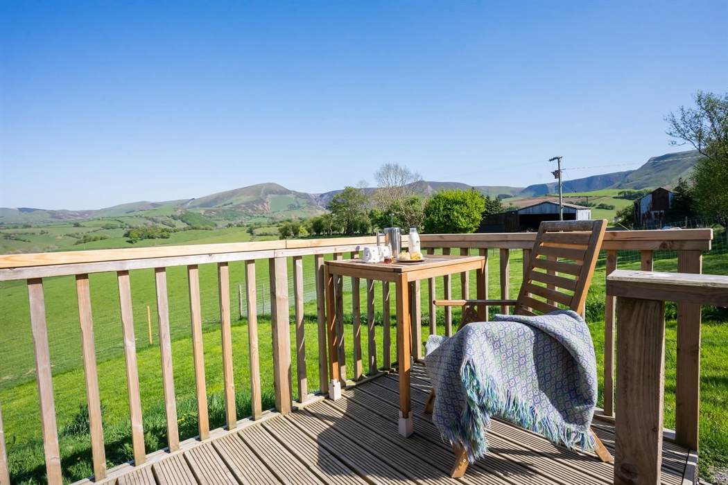 Out on the decking with the summer table at 80cm high and chair, looking over the fields. It’s a beautiful sunny day and you’re enjoying a croissant a