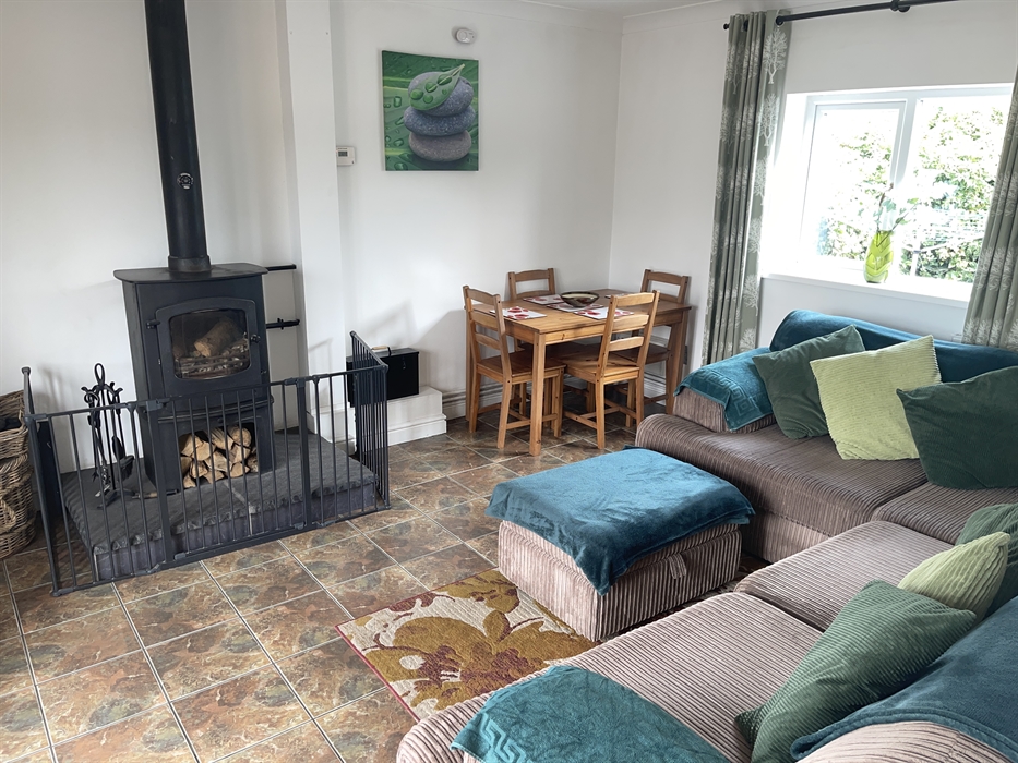 shows the corner sofa, rear window, table and 4 chairs and the Charnwood Cove multi-fuel fire