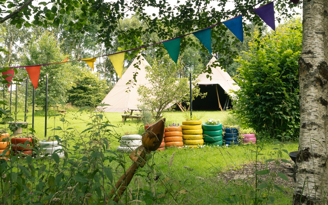 Large twin tepee on the lawn for play and event space with colourful tiers