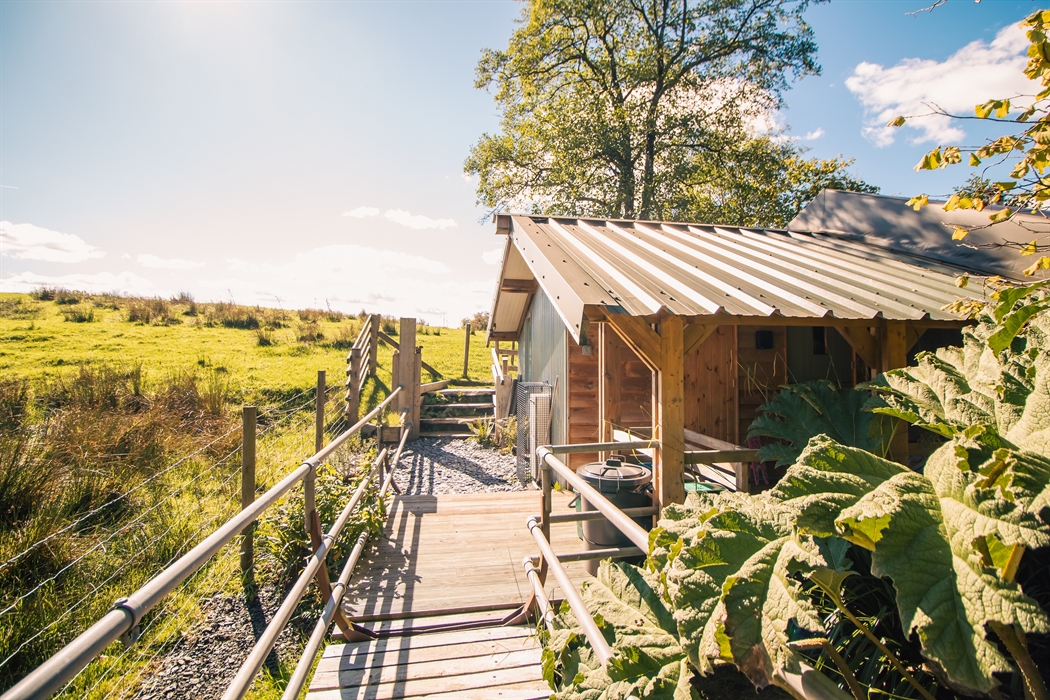 Entrance over a short bridge to your covered porch surrounding by fields and wildlife.