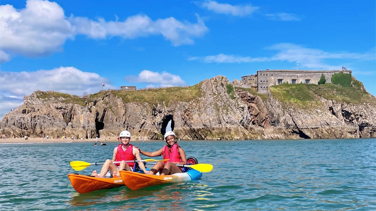 Couple in sit on top kayaks with St Catherine's Island in the background