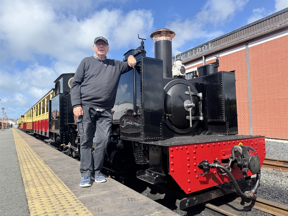 Pete Waterman standing in front of a Vale of Rheidol steam engine