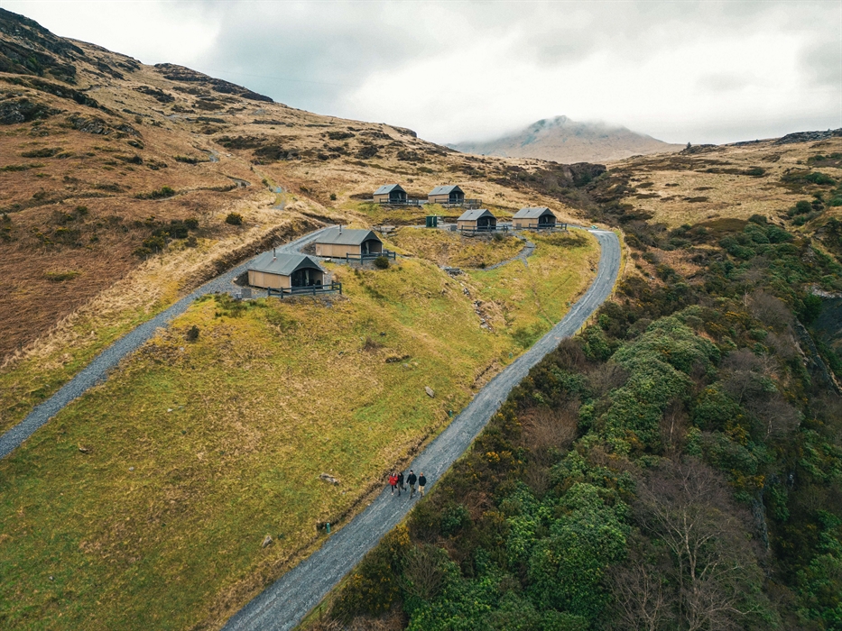 Drone shot of the exterior of Llechwedd Glamping Tents at Plas Weunydd on the side of the mountain