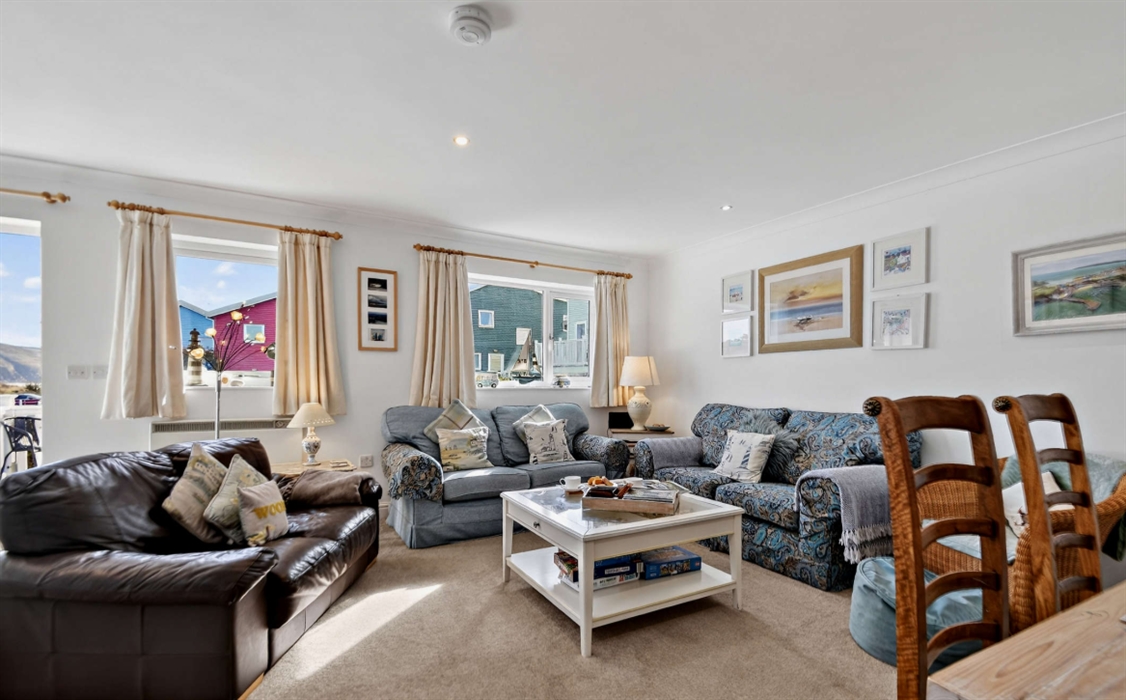 The lounge, 3 x 2 seater settees, Coffee table, dining table for six, dresser with lovely china, books, and games.