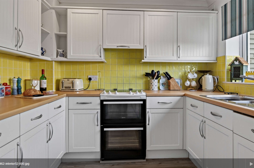 You come into the house via the kitchen. A bright one with yellow tiles.  Electric double oven, convector microwave, slow cooker and tons of kitchen e