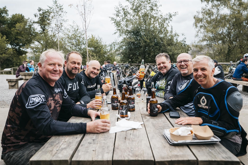 Friends enjoying a beer after riding