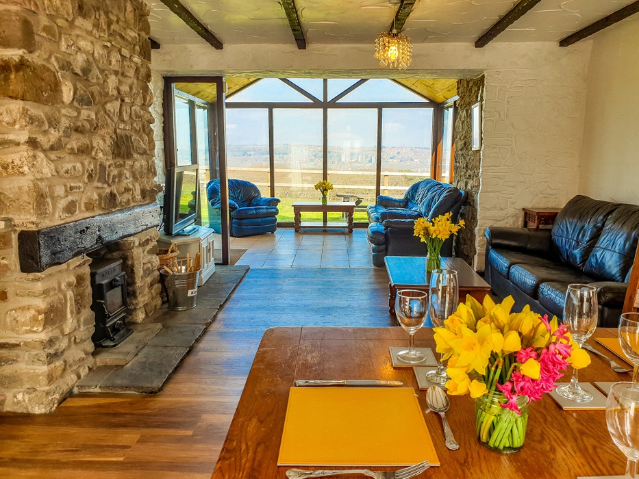 The Old Schoolroom, the largest cottage on the main farm site, includes a cosy wood burner and sun room