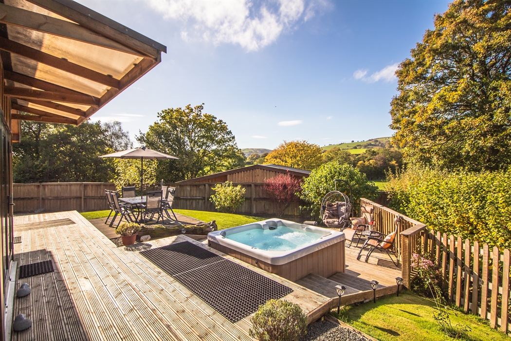 Ash Lodge veranda and patio with views across the countryside within a secure garden.