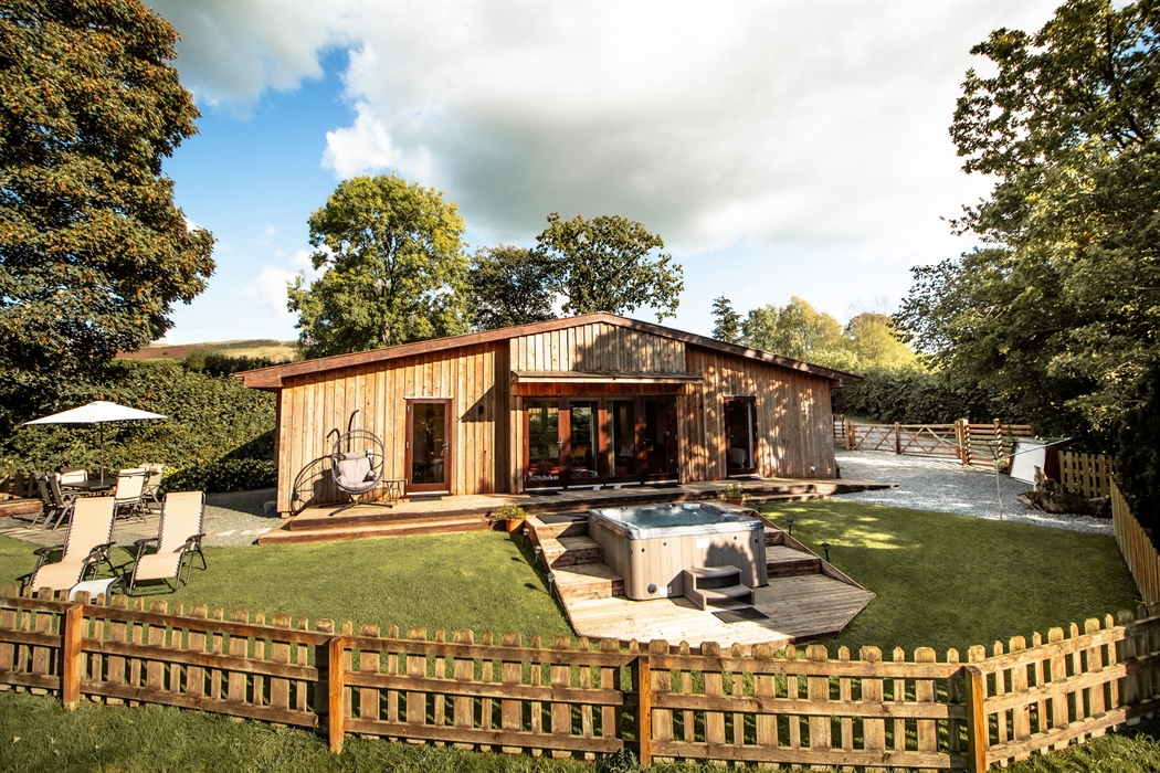 Sycamore Lodge fenced and secure garden with parking and storage shed.