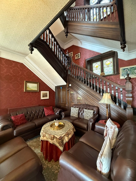 Lounge area of hotel with staircase