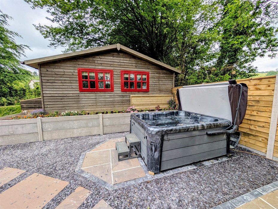 Hot tub outside Beech Lodge self-catering cottage at Wellstone Cottages Pembrokeshire.