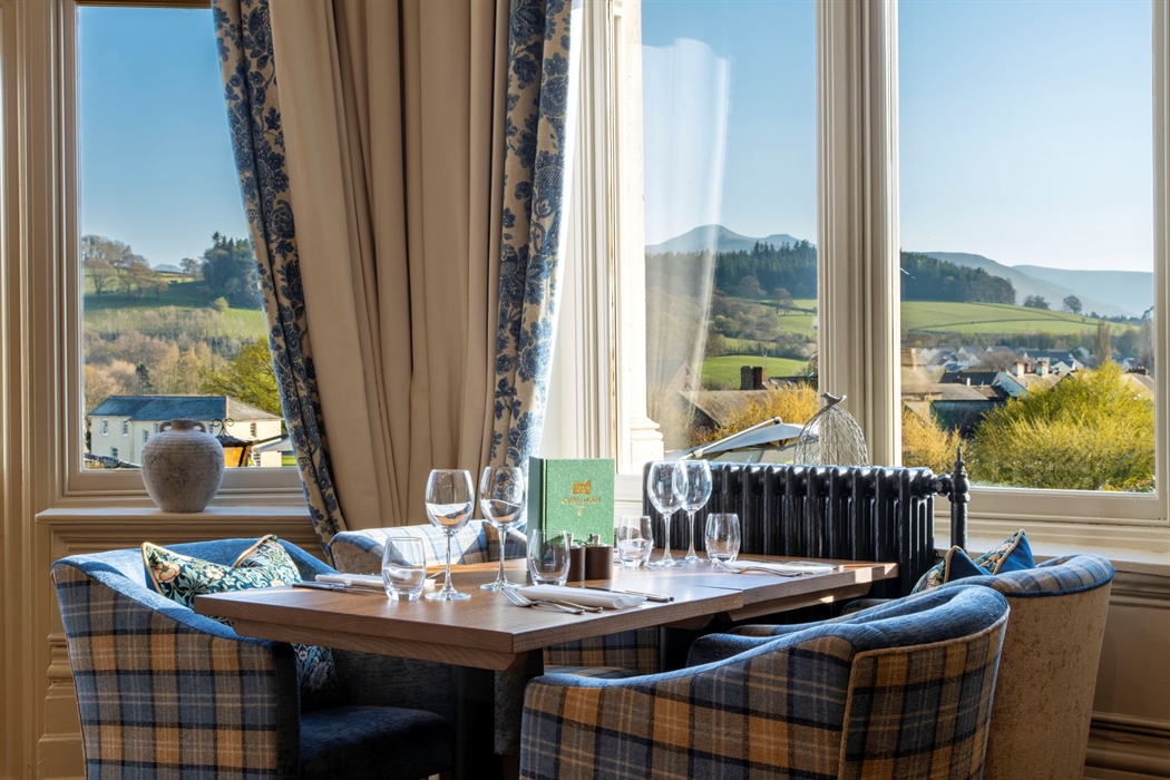 Table in a restaurant with a view of the countryside from the window