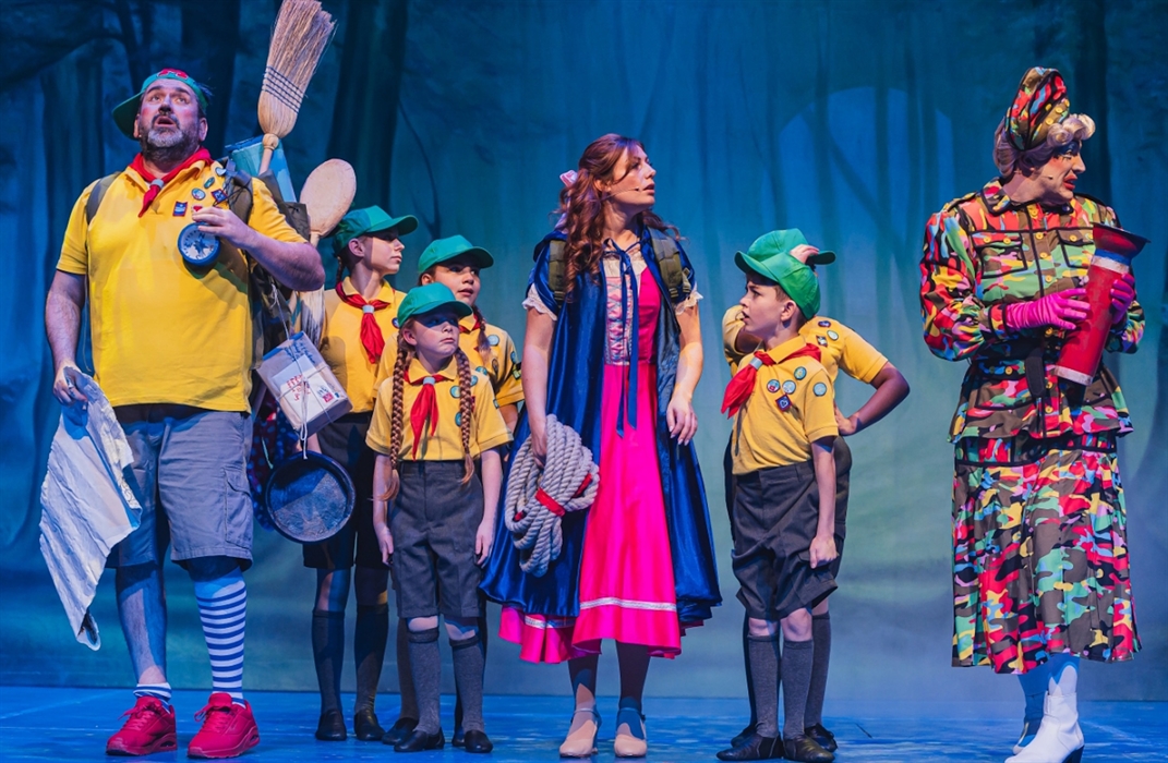 Eight performers on stage in a pantomime.