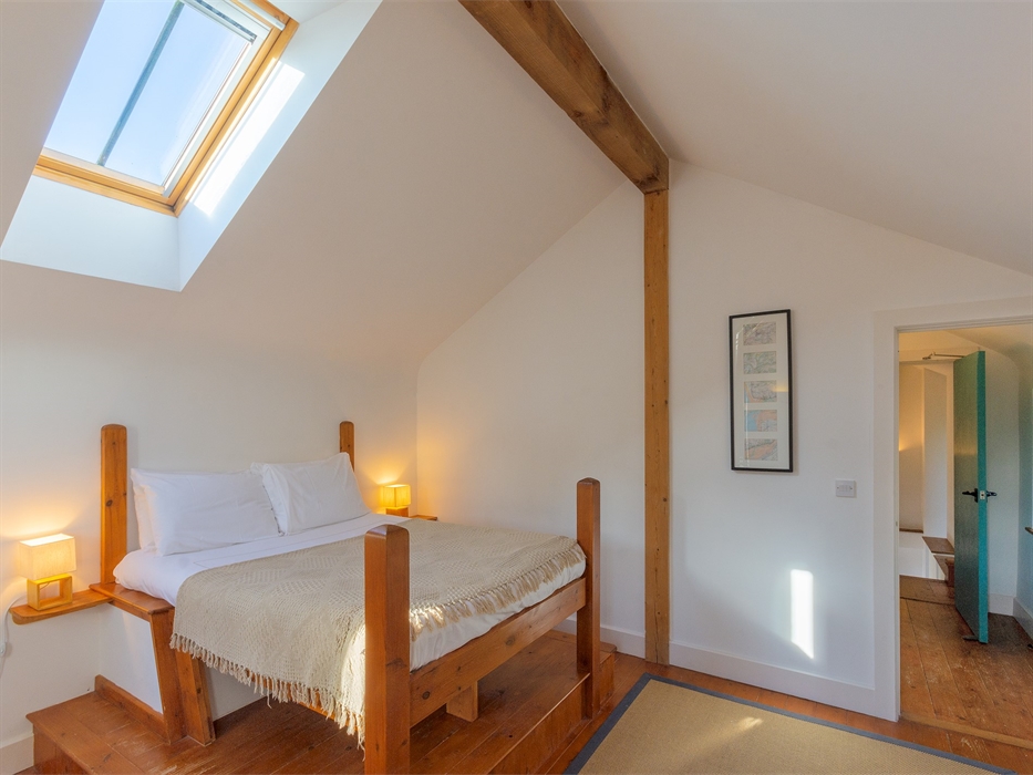 Double bed and skylight in upstairs bedroom