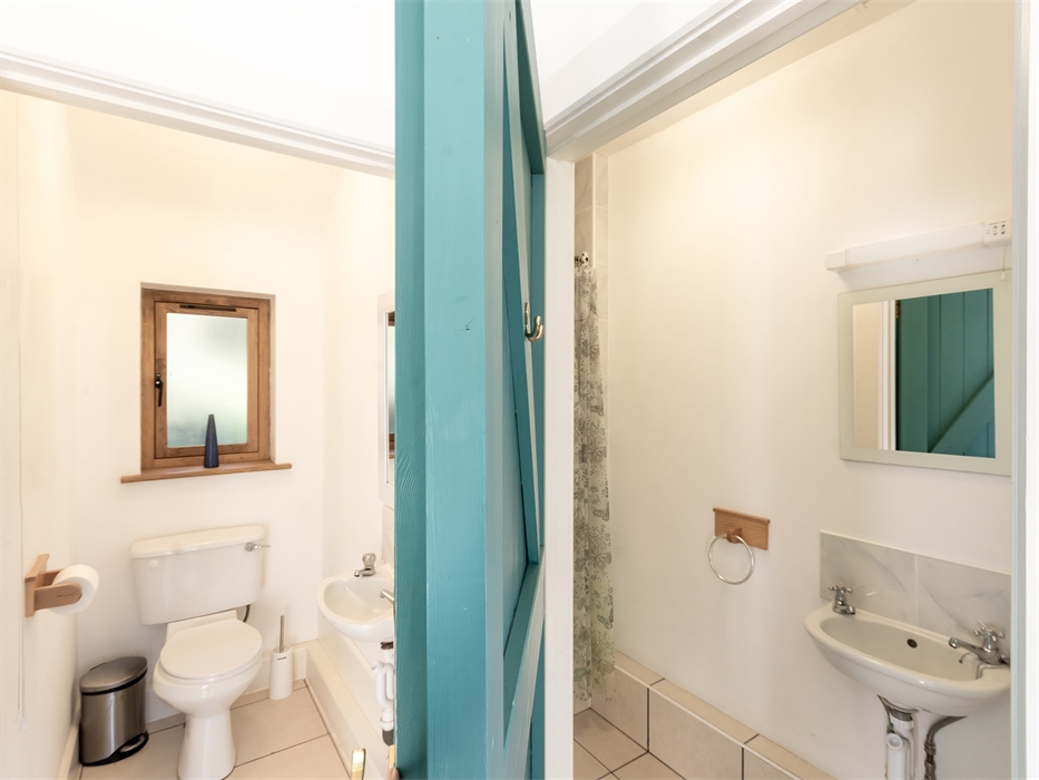 view into open doors of ground floor WC and shower room