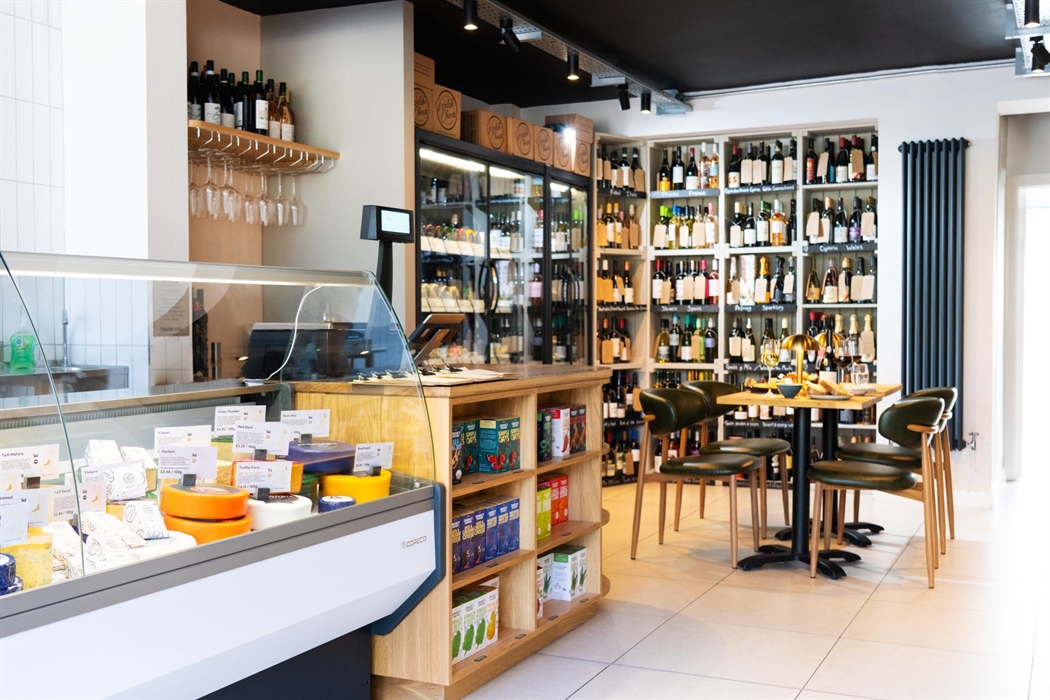 Cheese and wine counter display at a deli