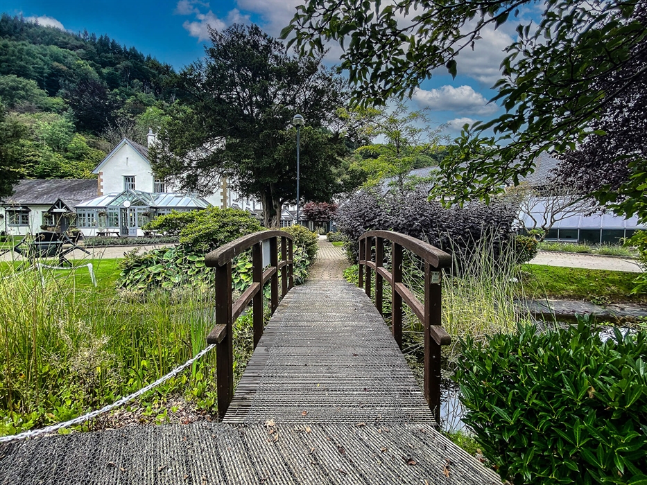 Exterior of Wild Pheasant Hotel & Spa with a landscaped garden in the foreground and the hotel building in the background, showcasing the peaceful cou