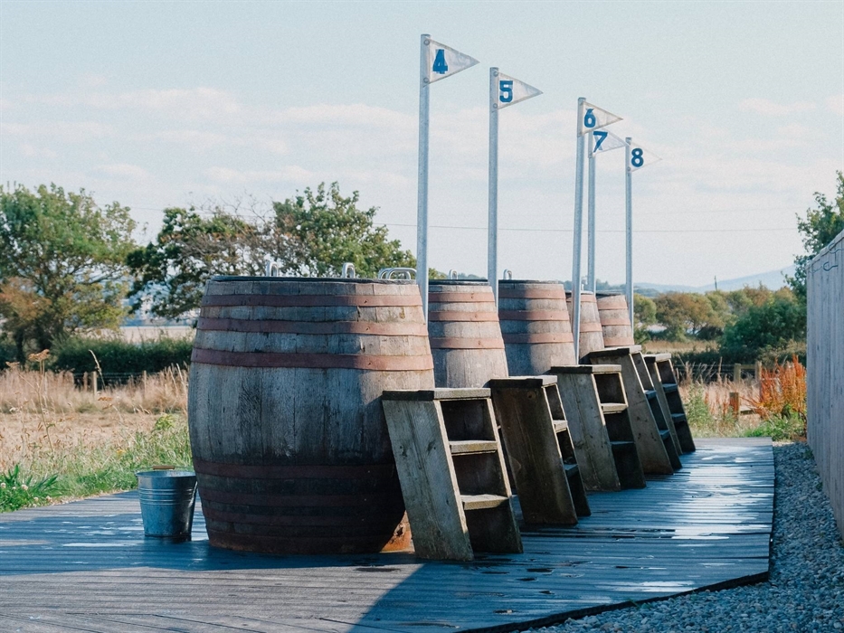 A view of the bathing barrels and steps at Halen Môn's Wild Môn Seaweed Baths