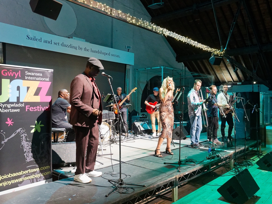 A band playing on a stage at the Swansea Jazz Festival