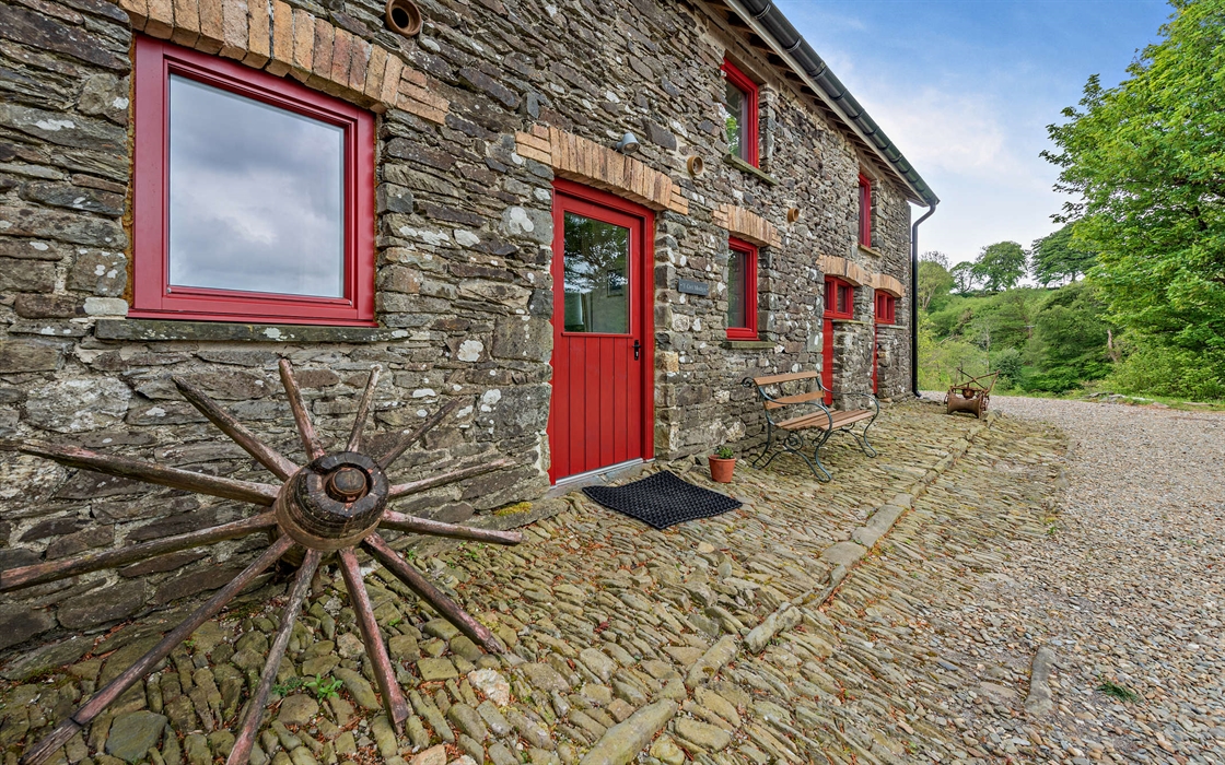 The apartment is located on the ground floor of the converted barn in Carmarthenshire, with its own entrance from the courtyard overlooking the large