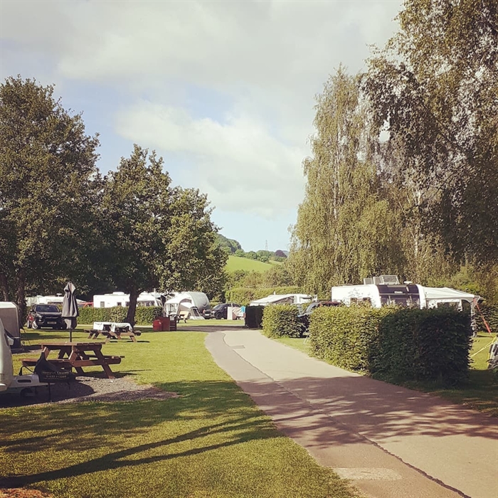 Pont kemys caravan park main site with tarmac road and hardstanding pitches surrounded by trees and hedges in South East Wales